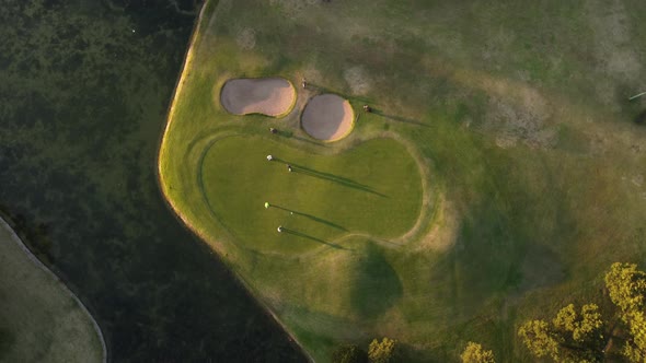 People playing at Golf Club José Jurado at sunset in Buenos Aires, Argentina. Aerial top down circli