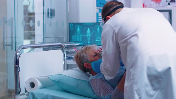 Doctor Putting Oxygen Mask on Senior Patient