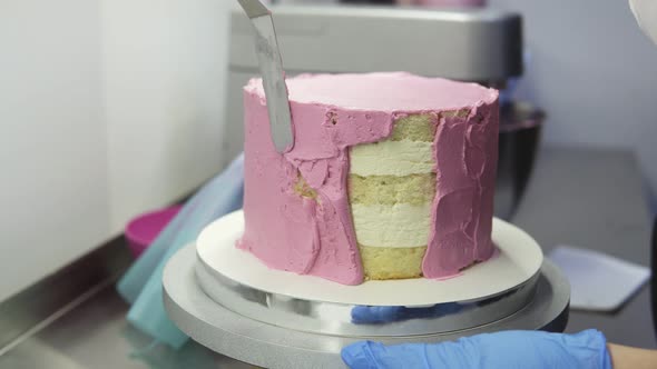 The Process of Decorating a Cake with Purple Cream Cover
