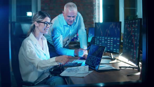 Stockbrokers are Highfiving While Analyzing Data Reports