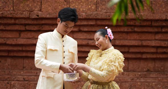 Young Thai couple enjoy splashing water on Songkran festival