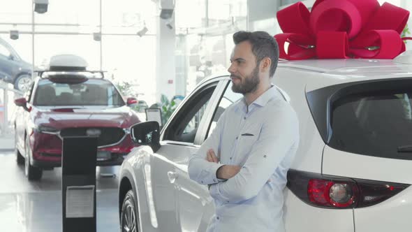 Handsome Male Driver Holding Car Keys To His New Auto at the Dealership