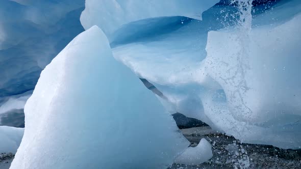 Blue White Ice of a Glacier Inside of an Ice Cave. The Glacier Is Melting Down and Water Is Flowing