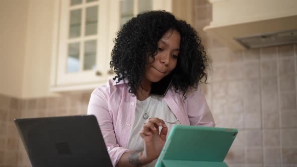 Busy Confident African American Woman Talking on Phone Messaging Online on Tablet Surfing Internet