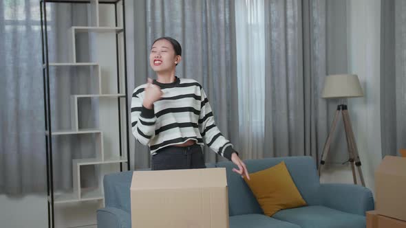 Happy Asian Woman Celebrating Finish Carrying Cardboard Box. She Celebrates Moving Day 