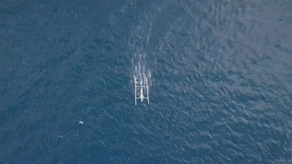 Aerial View of Tropical Blue Ocean with a Small Boat Moving Speedily