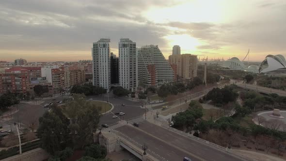 Flying Over Valencia at Sunset, Spain. Cityscape with Bridge and Buildings