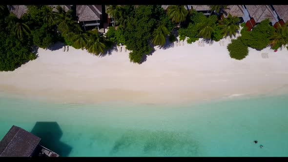 Aerial flying over texture of tropical tourist beach break by blue sea and white sandy background of