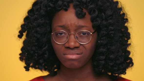 Afro Woman Saying No and Shaking Head in Disbelief Over Yellow Background