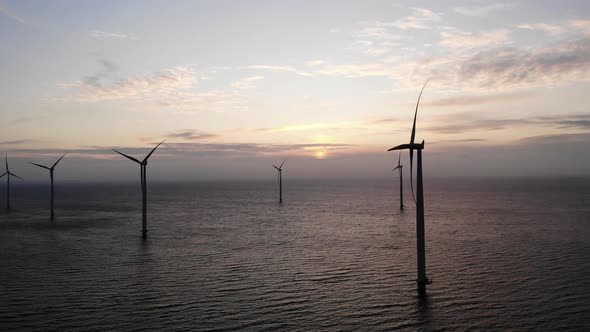 Offshore Windmill Park with Clouds and a Blue Sky Windmill Park in the Ocean Drone Aerial View with