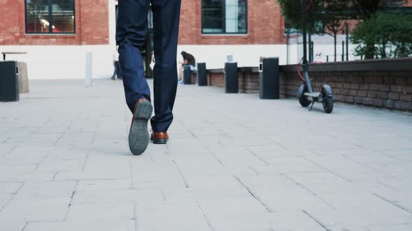 Unrecognisable Businessman Feet Walking in the Business District