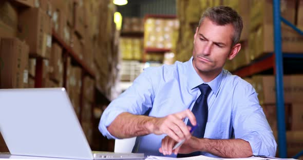 Warehouse Manager Working on Laptop