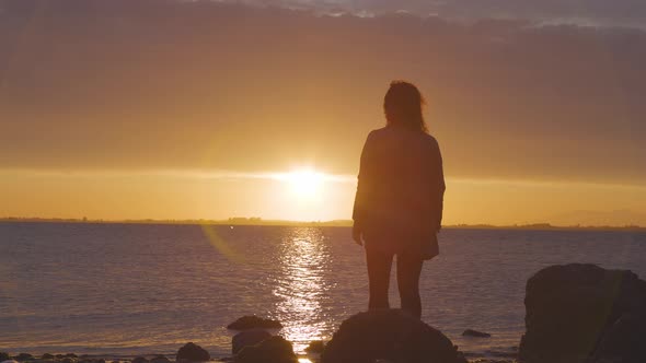 Adventure Caucasian Adult Woman Standing on a Rocky Beach