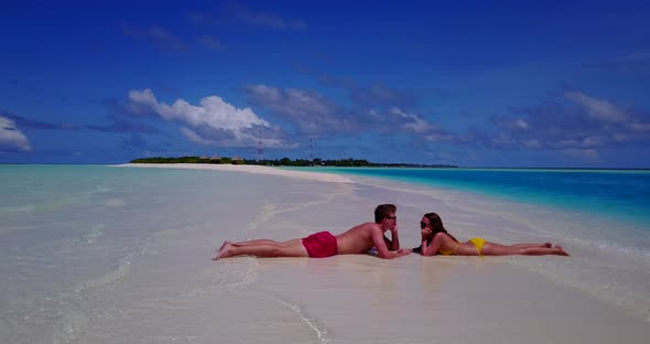 Fun couple on romantic honeymoon have fun on beach on clean white sand 4K background