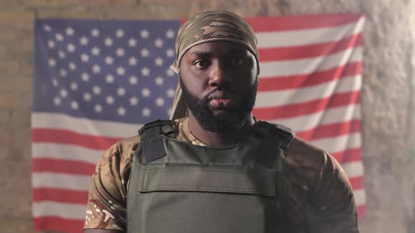 Black Army Man Posing on Background of US Flag