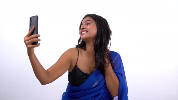 Indian woman in saree taking selfies