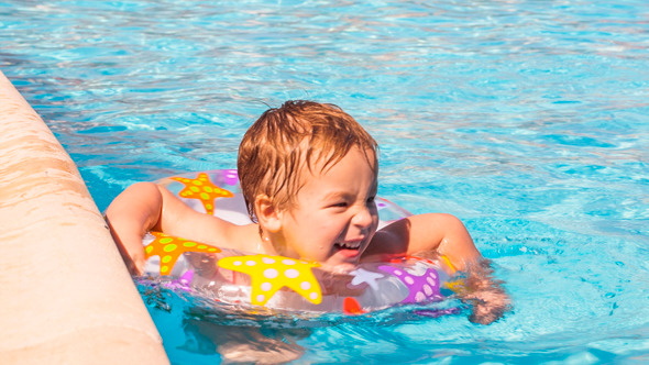 Boy Swimming With inflatable Ring