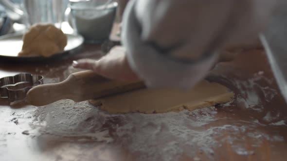 Female Hands Flatting Dough Using Rolling Pin