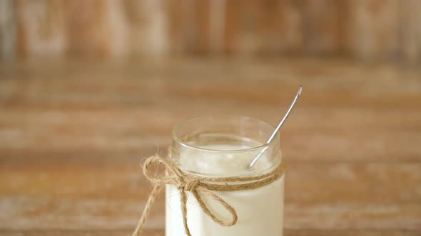 Yogurt or Sour Cream in Glass Jar on Wooden Table 27