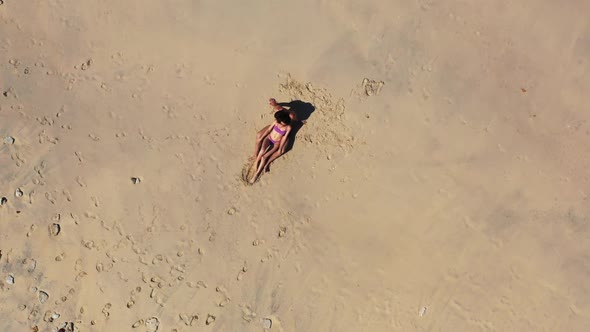 Man and woman engaged on relaxing island beach lifestyle by transparent ocean and white sand backgro