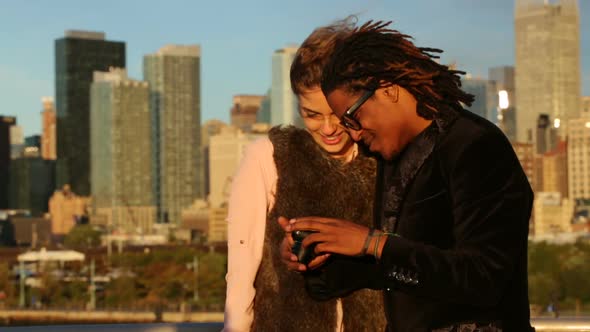 Couple talking self portrait in front of city skyline