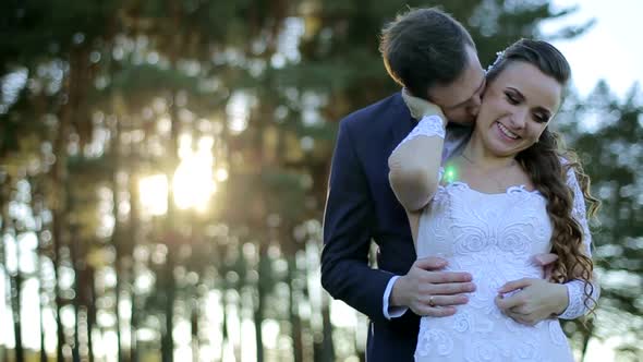 Loving couple in the woods, happy brides, wedding day