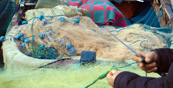 Fisherman Repairs Fishnets