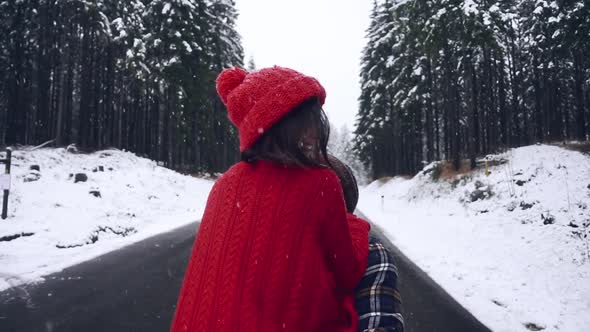 Happy Winter Couple Together in the Winter Forest