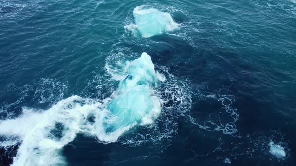 Iceberg in the Ocean Huge Chunks of Blue Ice Floating on the Waves Arctic Landscape Aerial View