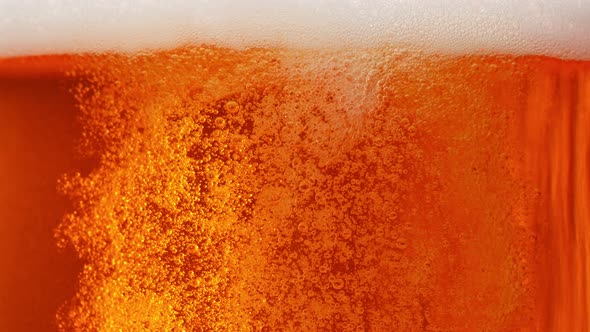 Super Slow Motion Shot of Rising Beer Bubbles and Fresh Foam Background at 1000Fps