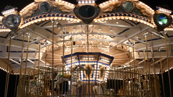 Illuminated Merry Go Round in Park. Brightly Illuminated Roundabout Spinning in Wonderful Amusement