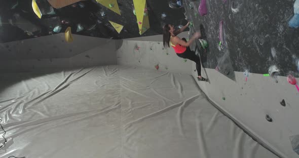 Bouldering Female Climber Training on a Climbing Wall Young Woman Practicing Rockclimbing