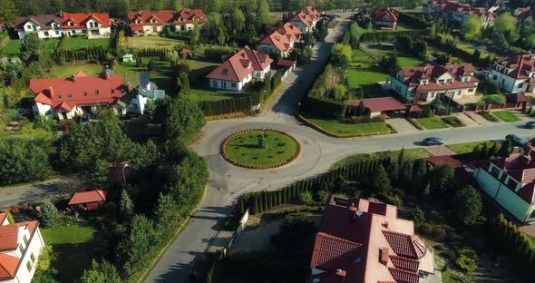 Aerial approaching view of a central point of a housing estate in the suburbs.