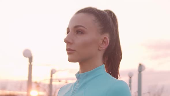 Young, beautiful and sporty woman having evening training outdoor.