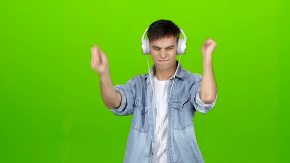 Guy Listens To Energetic Music in Headphones and Dances. Green Screen
