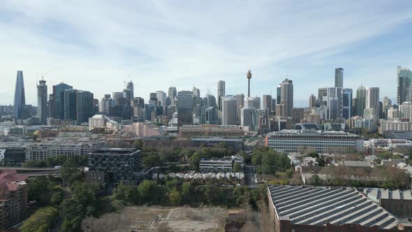 Aerial shot of Sydney City center in the morning, drone moving up over CBD revealing the beautiful s