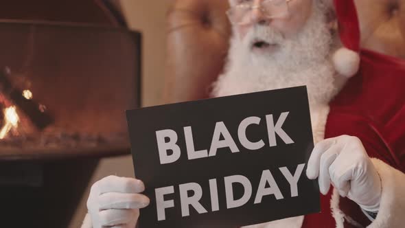 Blurred Santa Holding Black Friday Sign