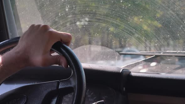 Close Shot of Hand Holding Steering Wheel Driving
