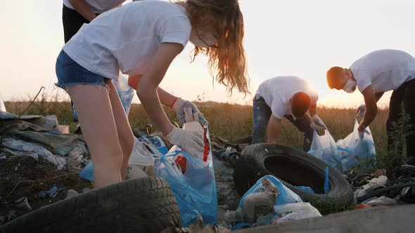 Group of Eco Volunteers Cleaning Up Area of Dump Near the Field During Sunset Gimbal Shot Slow