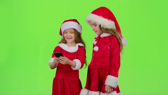 Two Children in New Year Costumes Do Selfie on the Phone, Green Screen