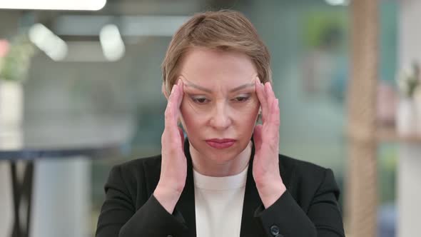 Stressed Old Businesswoman Having Headache 