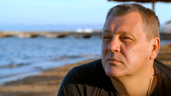 Handsome Middle-Aged Man Thinking At  Beach