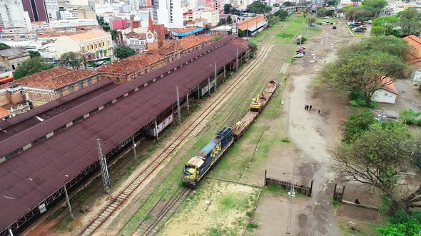 Drone footage of an old train station with an abandoned wagon in Campinas, Brazil