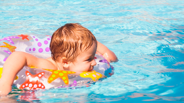 Kid Learns To Swim Using A Plastic Water Ring