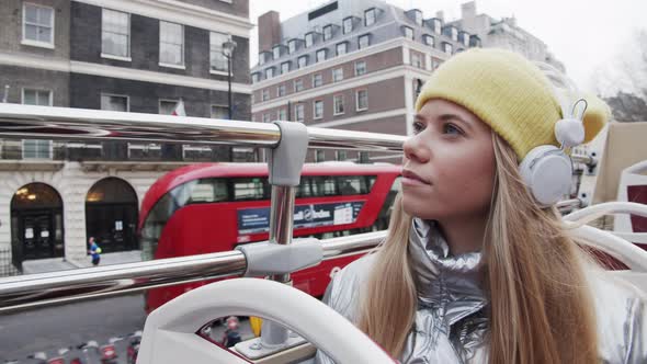 Blond Teenage Tourist With Headphones On Bus