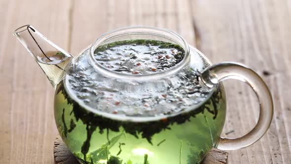 Japanese green tea (Genmaicha), pour hot water into teapot containing tea leaves.