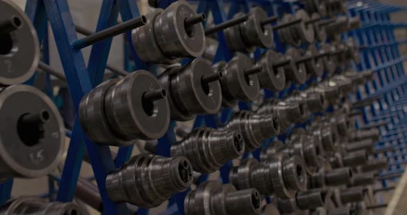 Round Metal Parts Hang in the Factory Floor Closeup