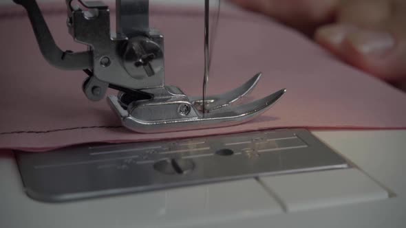 Slow motion frame of thread and needle.