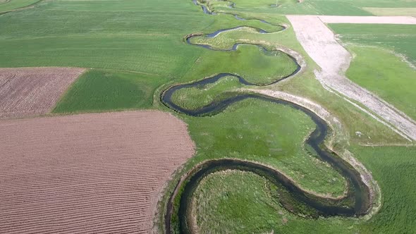 Meander Stream Between The Fields in Wide Valley