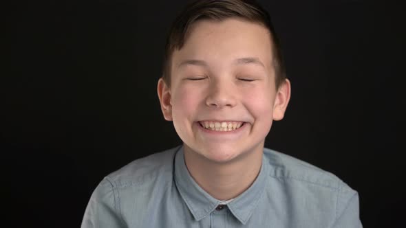 Portrait of Fun Boy Is Laughing and Looking at Camera